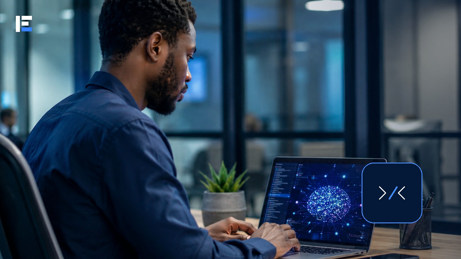An African developer working on code with a laptop in a modern office