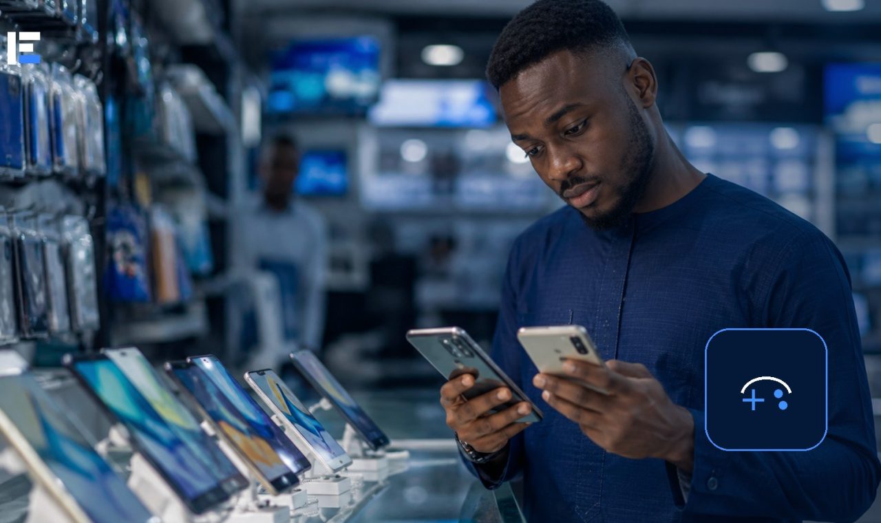A Nigerian shopper comparing smartphones for mobile gaming in an electronics store