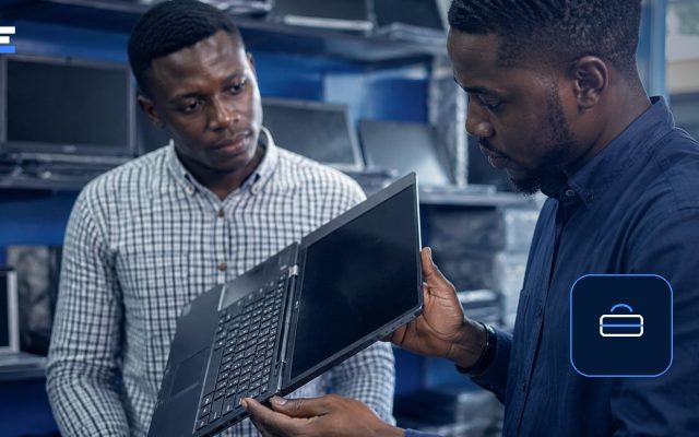 Two African professionals inspecting a laptop while checking a remote job offer